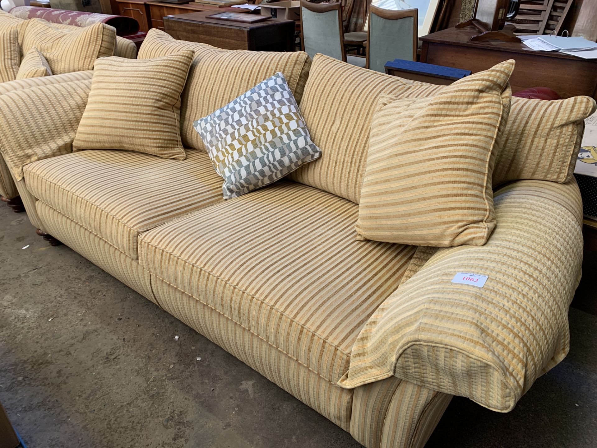 Three seat sofa upholstered in gold coloured striped fabric
