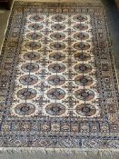 Beige ground rug and an Iranian red ground silk rug
