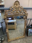 Gilt framed wall mirror with mirror surround and carved decorative mirrored pediment.