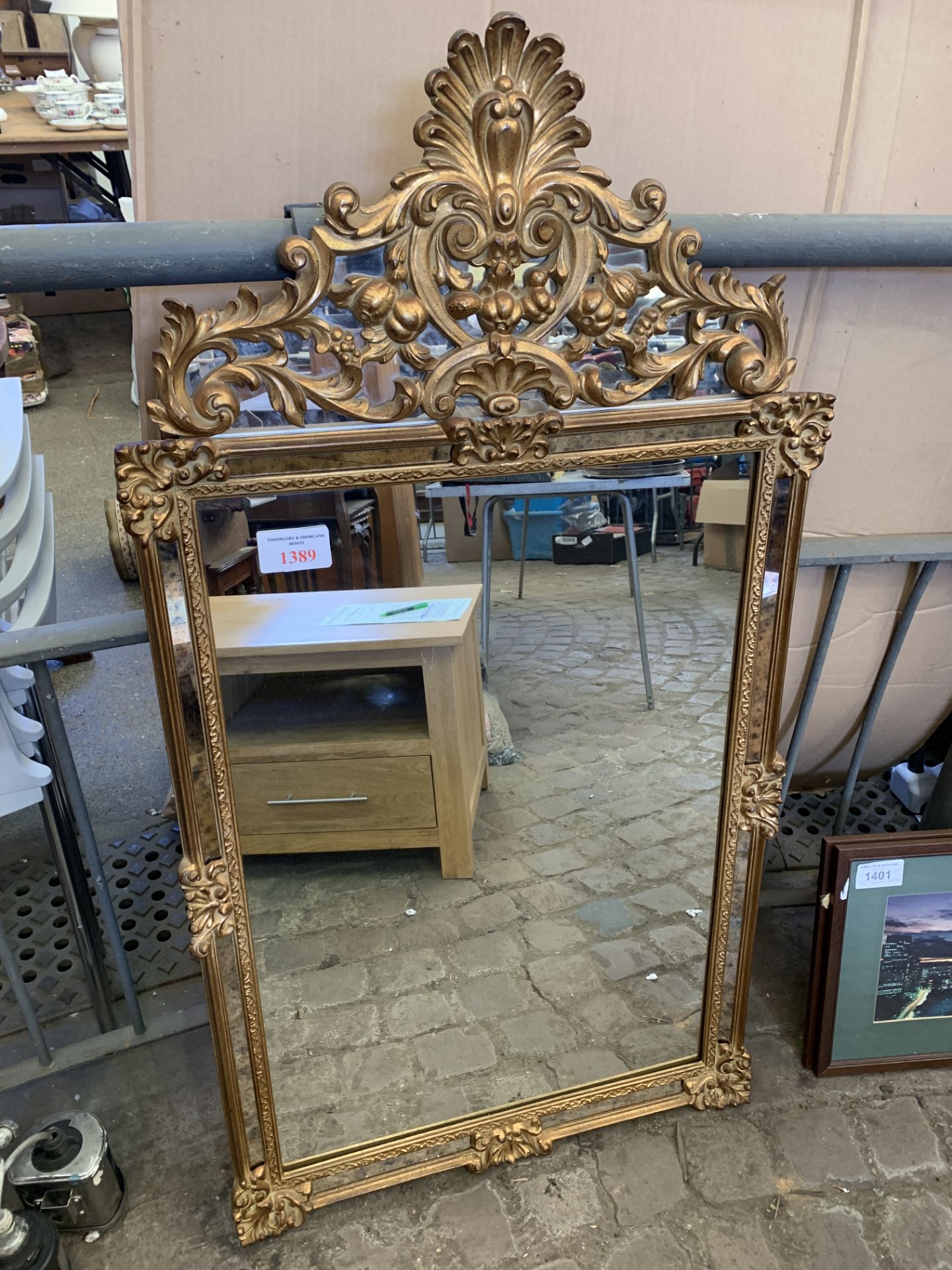 Gilt framed wall mirror with mirror surround and carved decorative mirrored pediment.