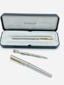 Two Parker fountain pens and a silver cased pencil