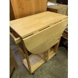 Laminated wood drop down gate leg table on casters