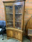 Mahogany concave fronted display cabinet over cupboard to base