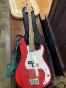 A Squier by Fender P-bass guitar and a Rocket B bass amplifier