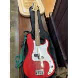 A Squier by Fender P-bass guitar and a Rocket B bass amplifier