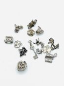 Six various silver marked charms and eight other silver coloured charms