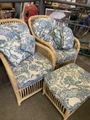 Two rattan style conservatory chairs and a foot stool