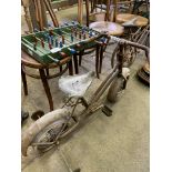 Two mid-20th Century children's bicycles and an early child's table football.
