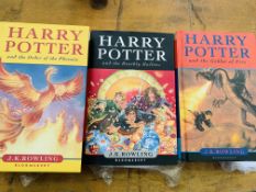 Two Harry Potter first editions, and another Harry Potter book