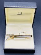 Two new and boxed Dunhill gold and silver coloured tie pins