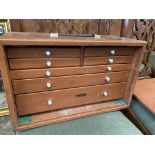 Teak case by Union containing four over three drawers which contains contents