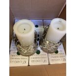 Two white metal candle holders and 21 boxes of 12 x 10" green candles