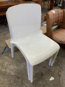 Two white plastic stackable chairs,