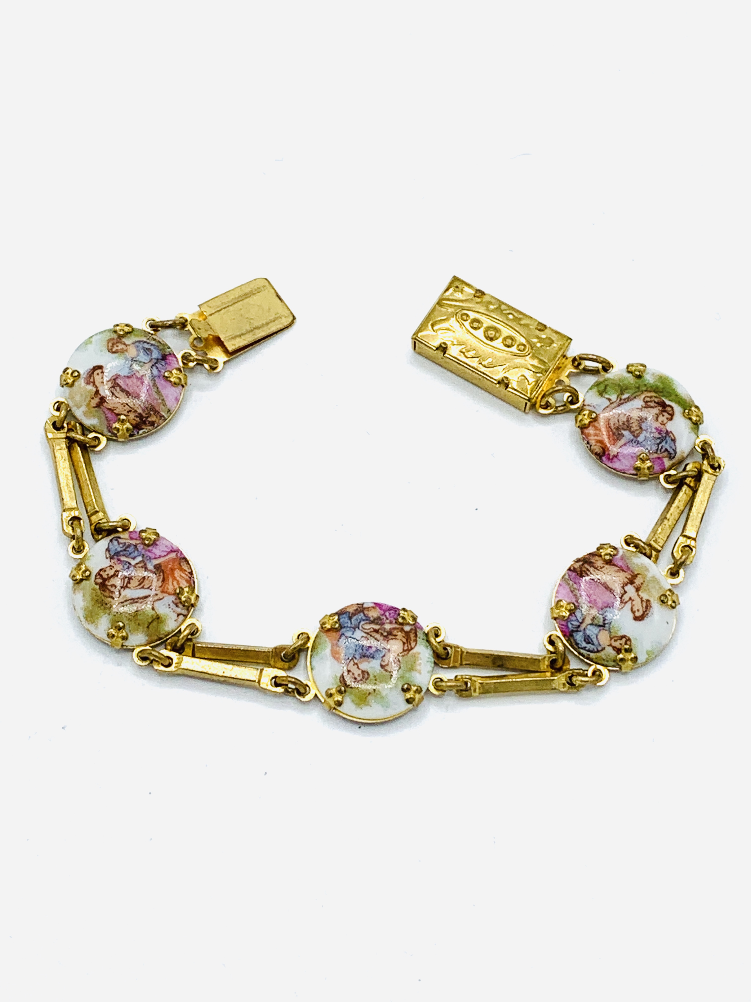 Yellow metal and porcelain bracelet