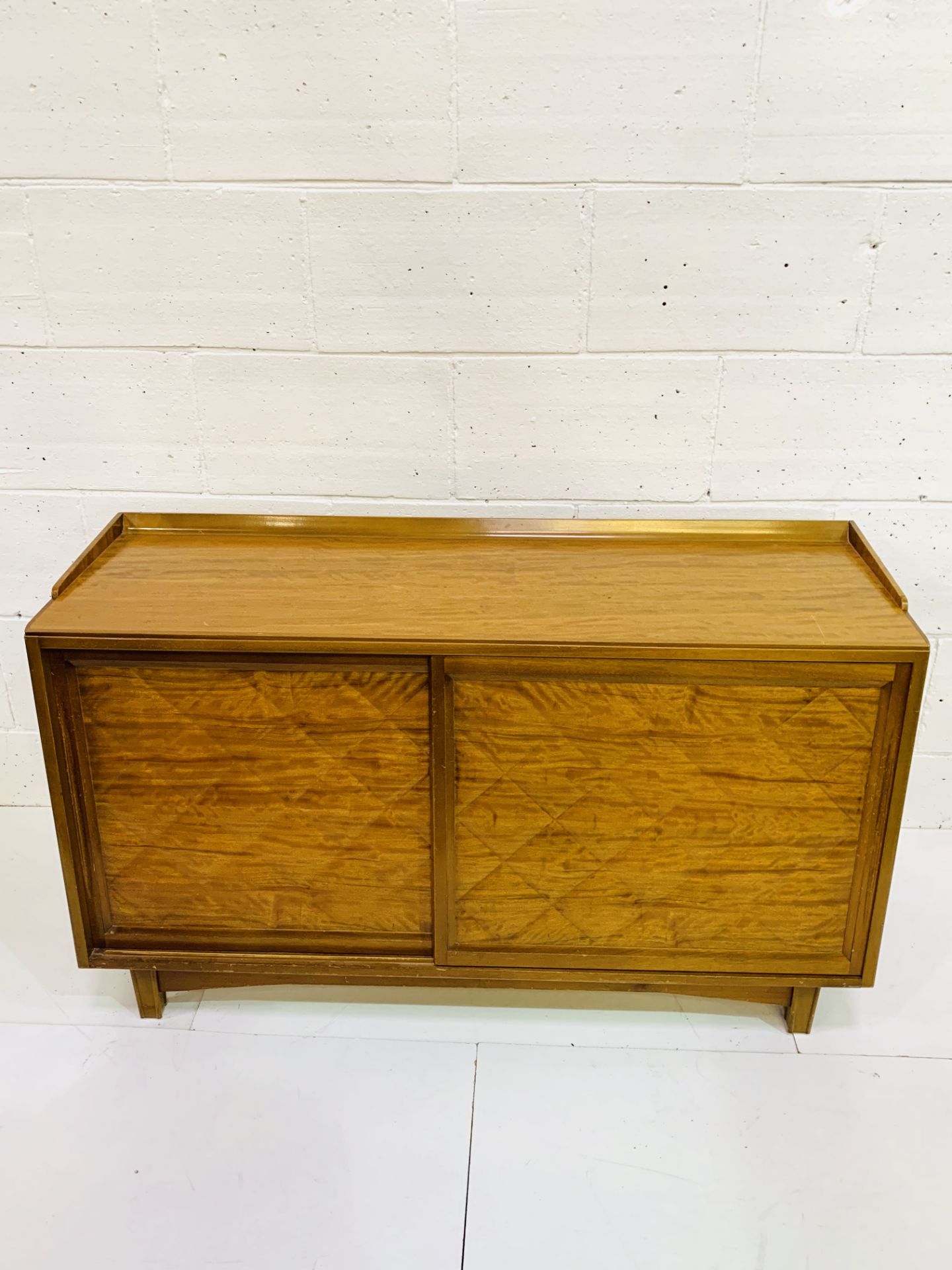 Dao hardwood sideboard with quilted effect to sliding doors.