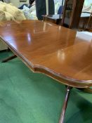 Mahogany shaped end extendable dining table together with two carvers and six chairs.