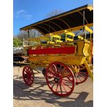 CHARABANC painted yellow and red with 21 wooden seats accessible via a rear staircase