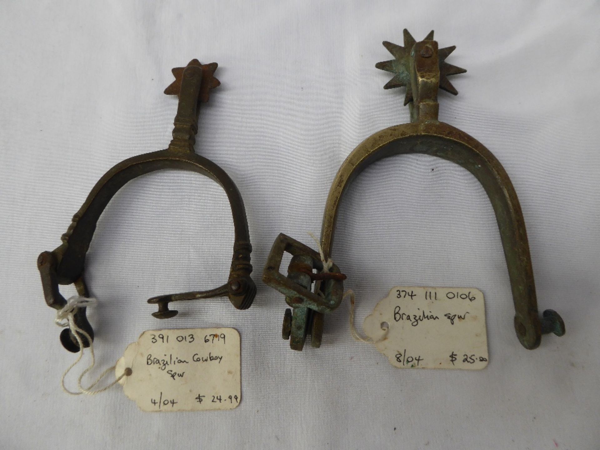 2 rowelled spurs.