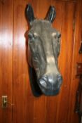 Full size display model of a horse's head.