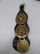 3 Horse brasses on leather strap - carries VAT.