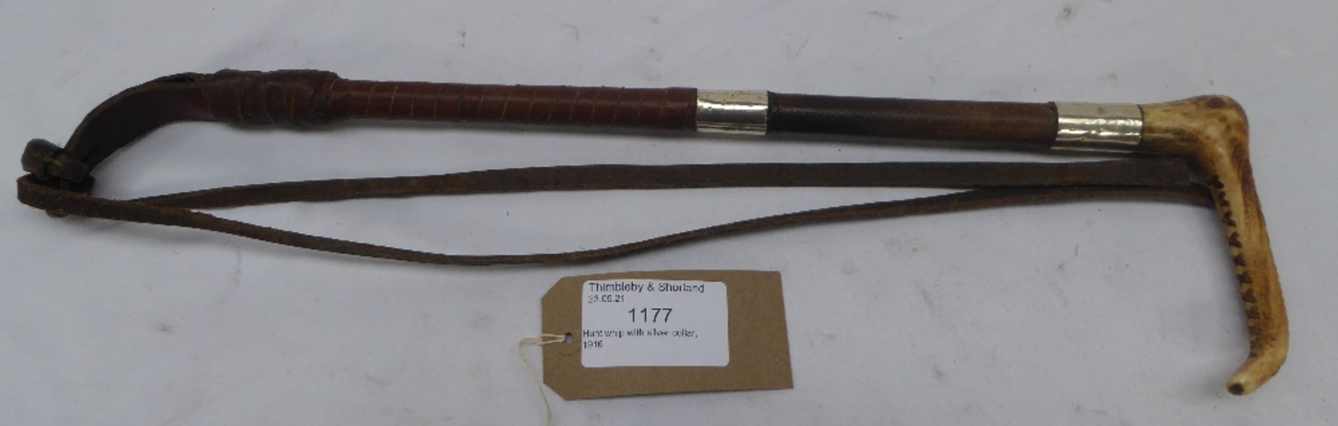 Hunt whip with silver collar stamped 'H.C. 1916 Schomberg, London', with a bone handle