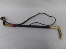 Hunt whip with bone handle and leather thong.