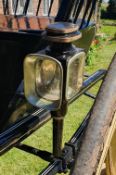 Pair of black square fronted carriage lamps with brass trim.