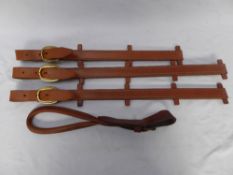 Three leather straps for a carriage seat, and a handle.