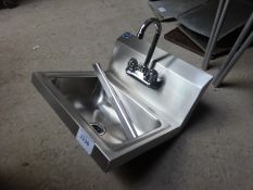 Stainless steel hand sink with tap.