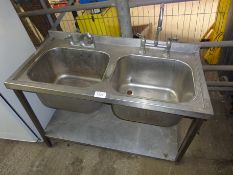 Double bowl sink with taps.