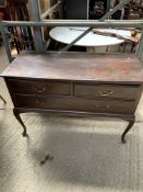 Mahogany chest of drawers and a brass floor lamp