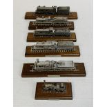 Six diecast model locomotives on wooden bases