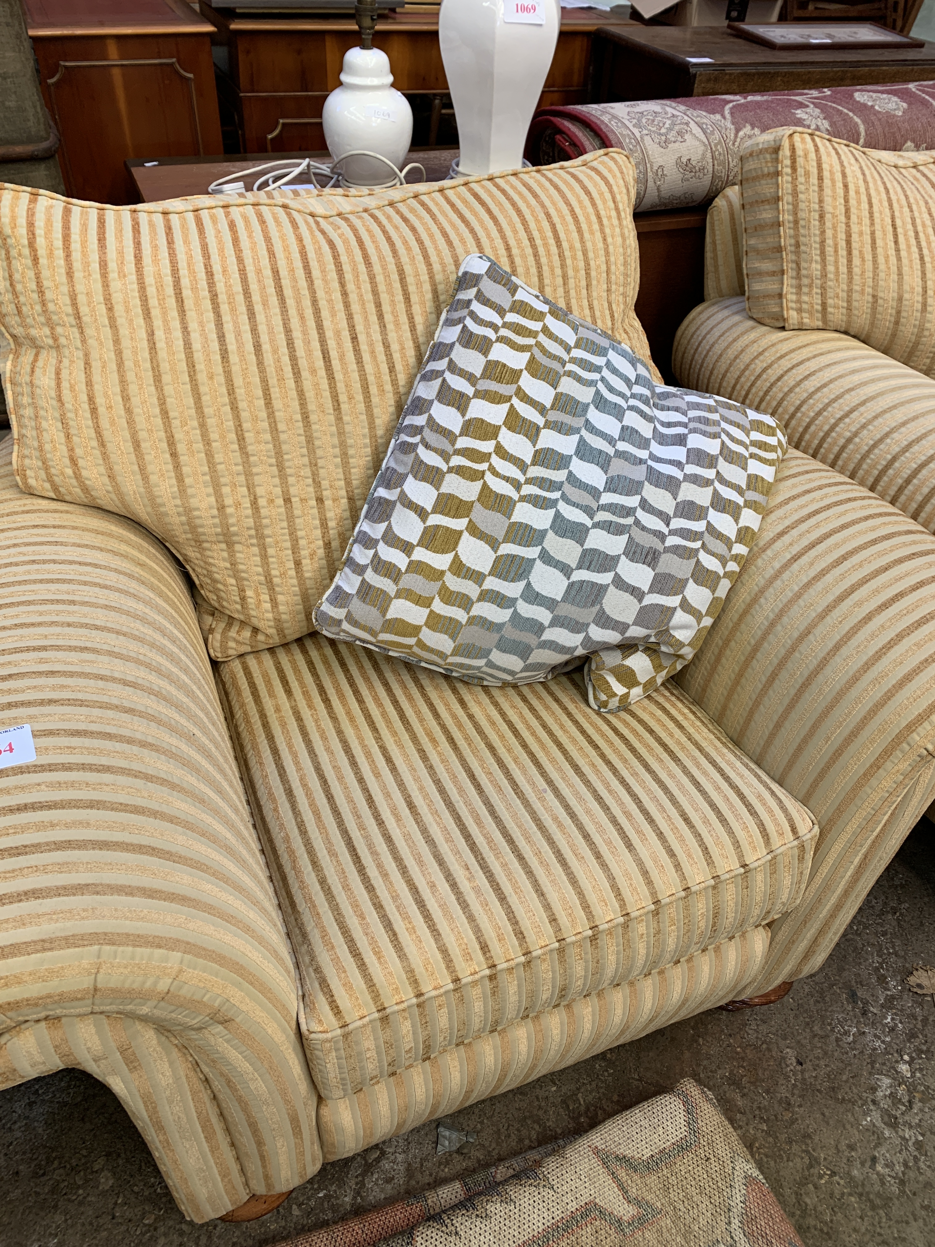 Two armchairs upholstered in gold coloured striped fabric