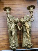 Pair of brass cherubic wall mounted candle holders