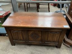 Oak chest with carved front and rising lid