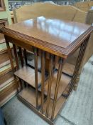 Walnut veneer topped revolving bookcase on casters