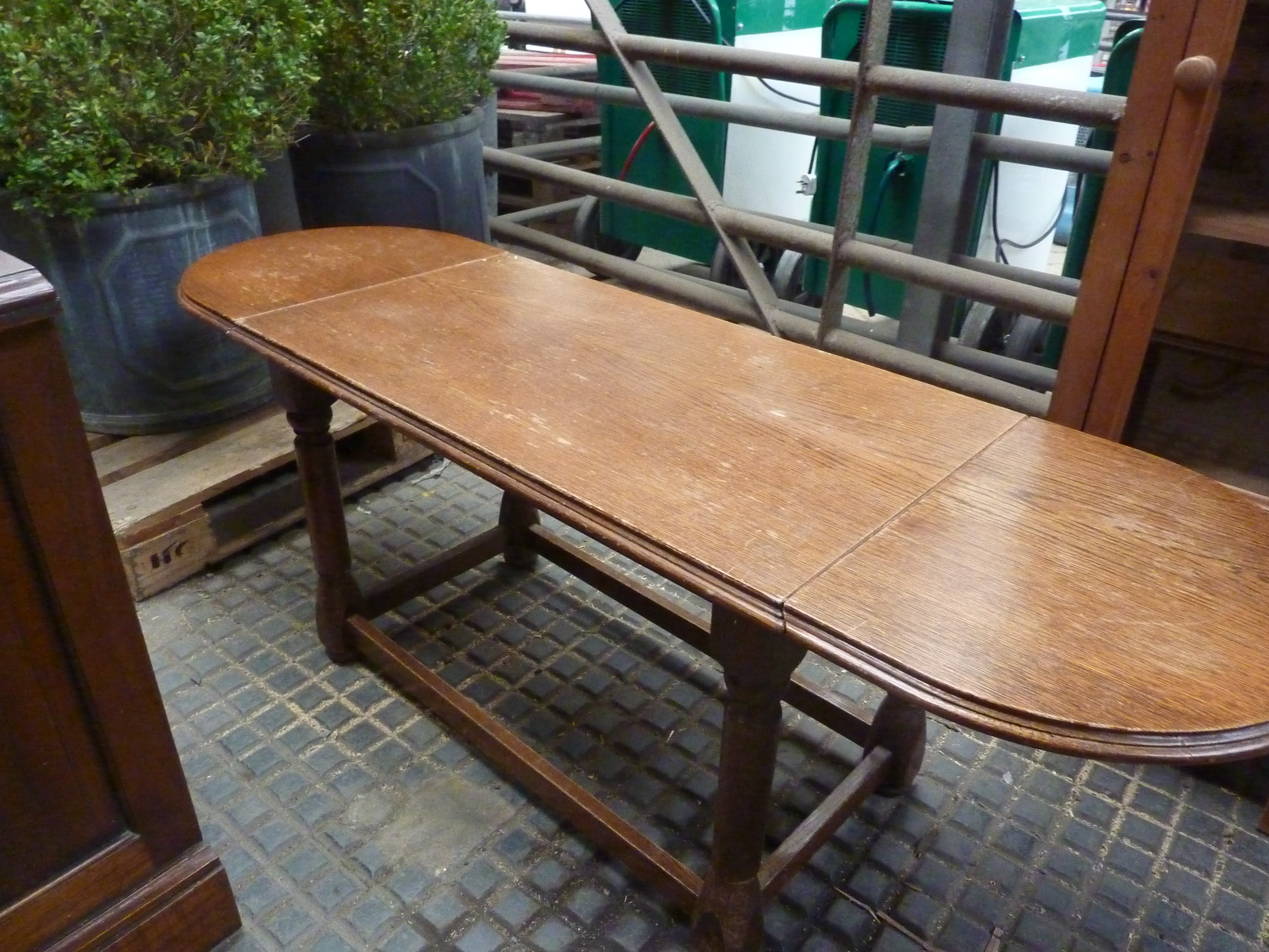Oak occasional table with drop sides; together with mahogany storage cupboard