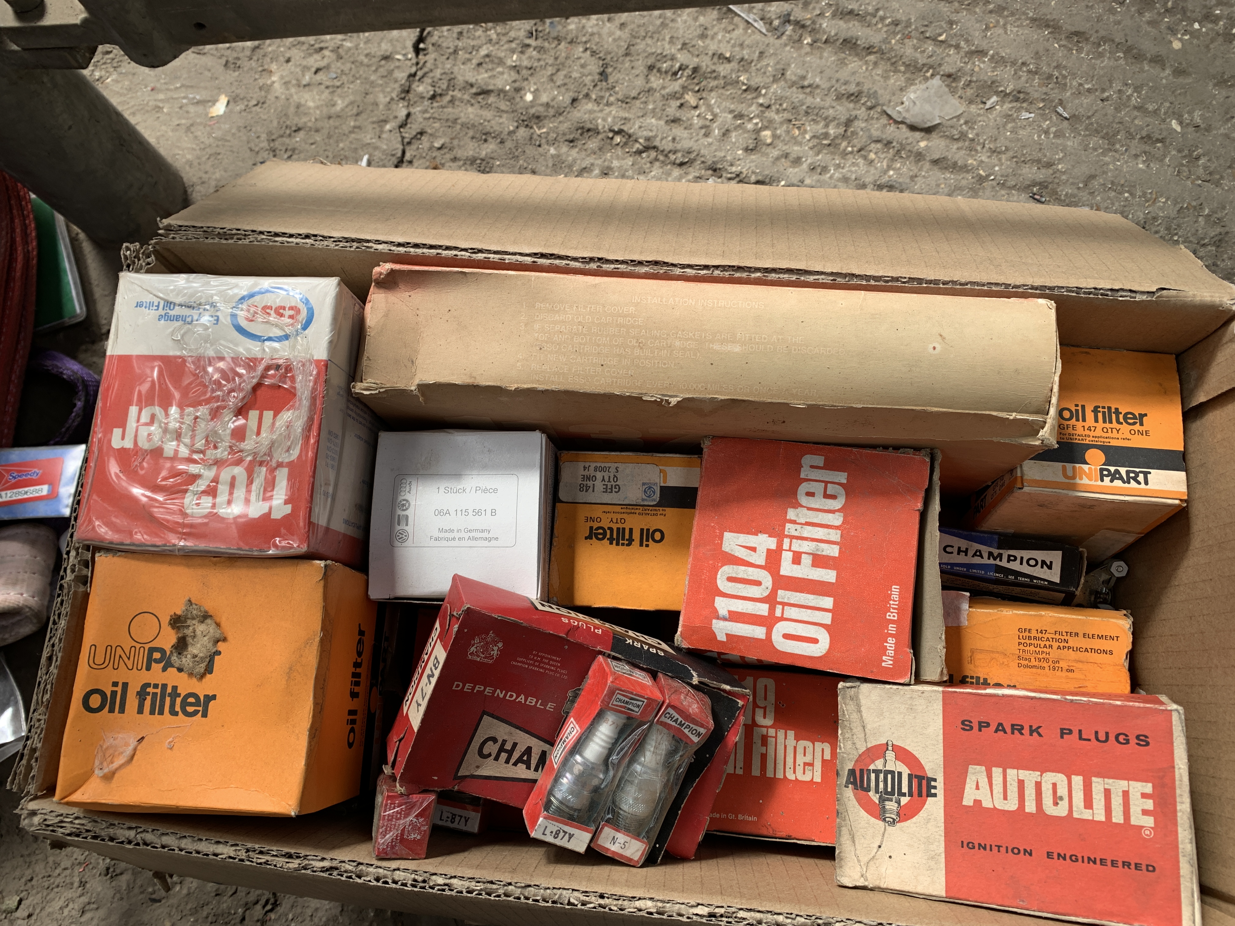 Large collection of car parts including air filters, oil filters and spark plugs