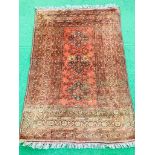 Red ground hand knotted rug