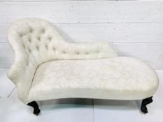 A Victorian chaise longue in button back cream floral pattern upholstery
