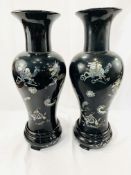 Two black lacquered wooden vases decorated with mother of pearl animals