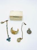 A crescent shaped 18ct gold mounted tooth brooch and other items in a small bone trinket box