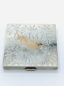 Silver and yellow metal hummingbird powder compact.