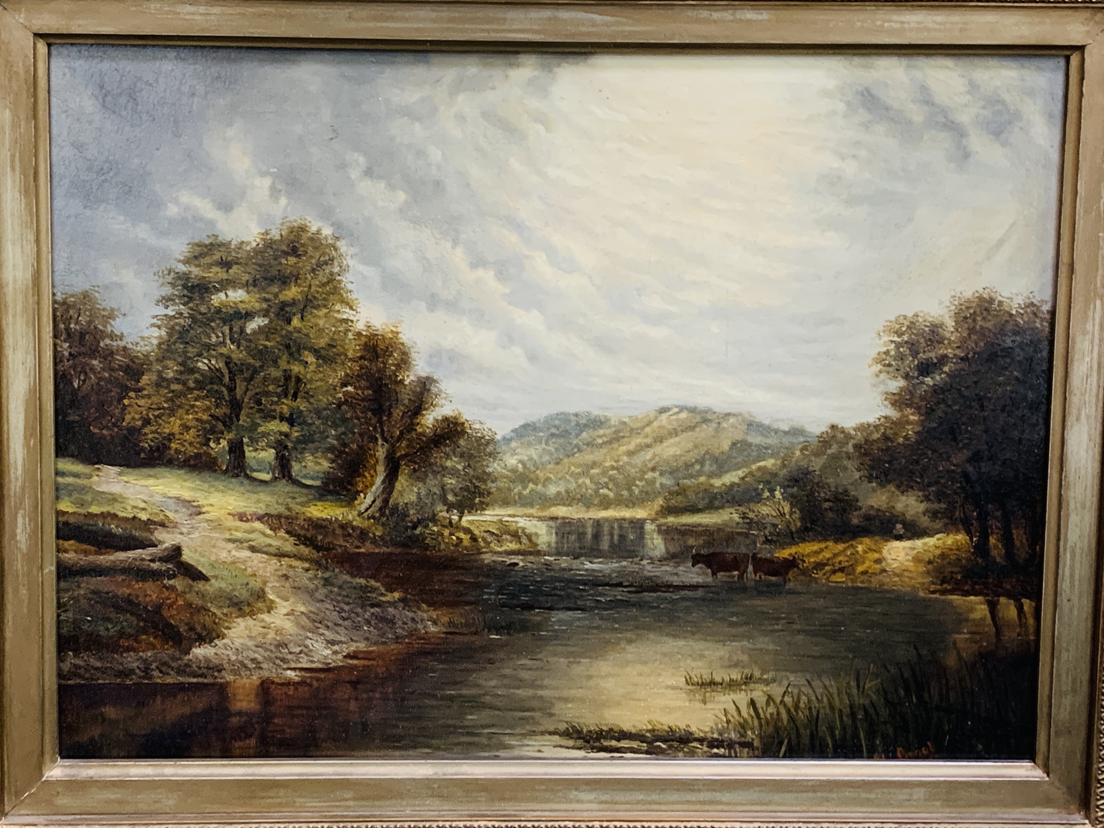 Gilt framed oil on canvas of river, trees and mountain scene with cattle