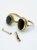 18ct gold ring set with a dark blue stone; together with a gold ring set with a dark brown stone.