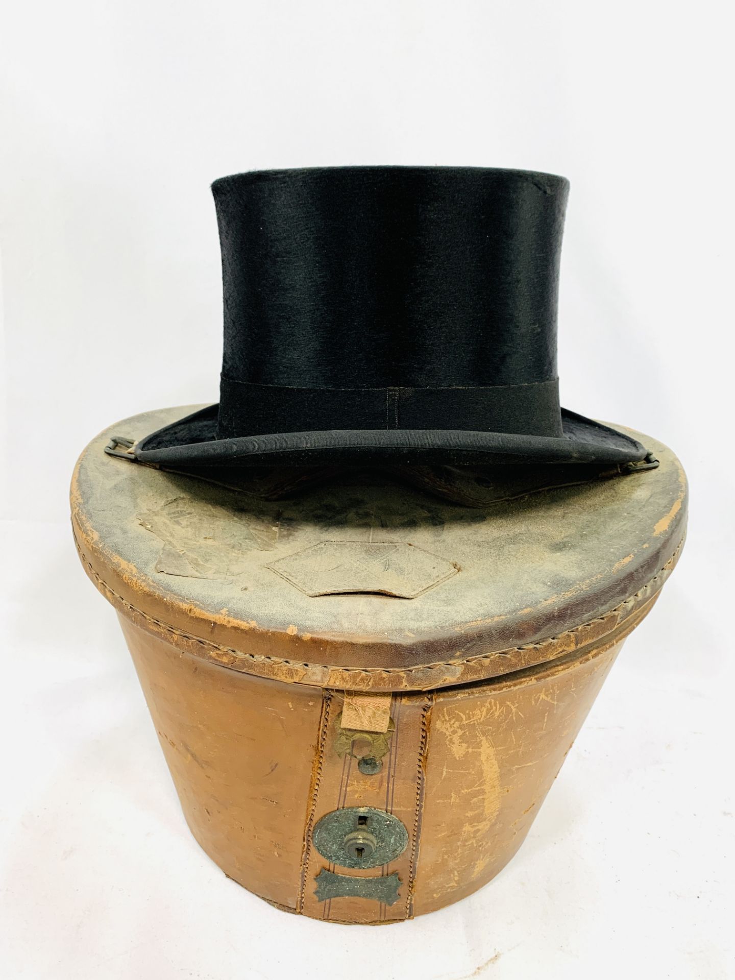 Black silk top hat by City Cork Hat Company Ltd. with leather hat box