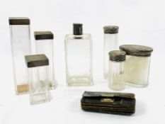 Seven silver topped glass dressing case bottles, a crocodile skin purse, and a salad bowl