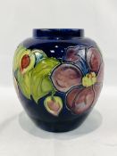 Moorcroft jar decorated with blue flowers and fruit