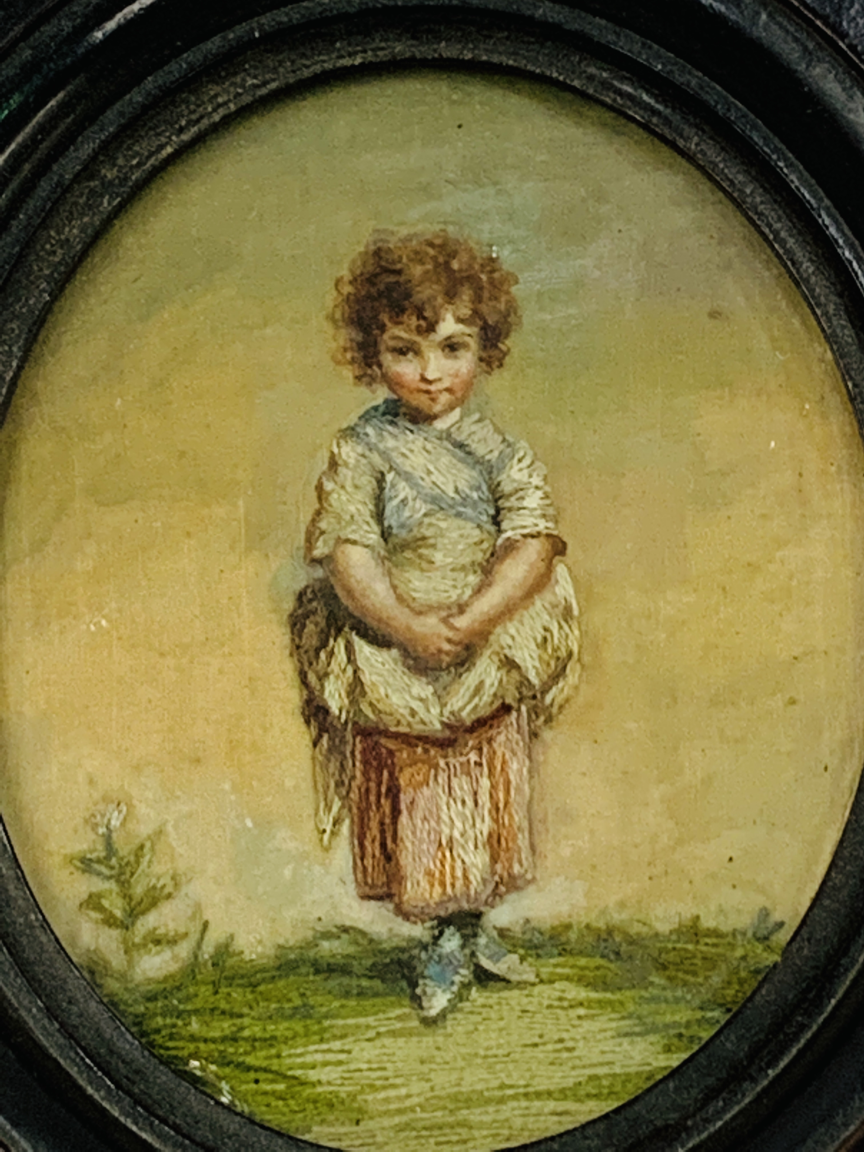 An oval framed and glazed embroidered miniature on silk of a young girl - Image 2 of 3