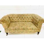 A floral upholstered button back Chesterfield sofa